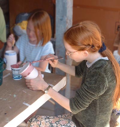 Painting a pot with underglaze